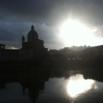 Sun and rain on Arno river