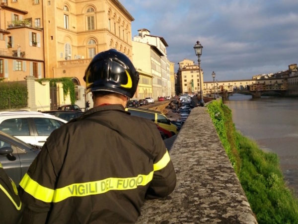Firefighters at work on the Lungarno after the collapse